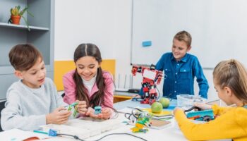 Schoolkids Working On Robot At Stem Robotics Lesson
